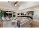 Open-concept living room and kitchen with modern furnishings and access to the balcony at 311 Spring Ave, Anna Maria, FL 34216