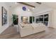 Cozy living room features a large sectional sofa, vaulted ceilings, and access to the balcony at 311 Spring Ave, Anna Maria, FL 34216