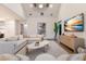 Bright living room with a sectional sofa, modern decor, and a TV at 311 Spring Ave, Anna Maria, FL 34216