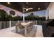 Covered patio features an outdoor dining area with seating for eight, ideal for enjoying meals in a lush tropical setting at 311 Spring Ave, Anna Maria, FL 34216