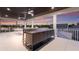 A covered outdoor kitchen and bar area with ceiling fans offer a fantastic entertaining space at 311 Spring Ave, Anna Maria, FL 34216