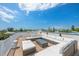 Spacious roof deck with plush seating, perfect for entertaining or relaxing with a view at 311 Spring Ave, Anna Maria, FL 34216