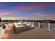 Spacious roof deck with plush seating, perfect for entertaining or relaxing with a view at sunset at 311 Spring Ave, Anna Maria, FL 34216