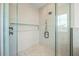 Walk-in shower with glass doors and modern fixtures, highlighting the clean and bright space at 311 Spring Ave, Anna Maria, FL 34216