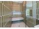 Modern shower with decorative tile, built-in bench, and glass enclosure for a spa-like experience at 311 Spring Ave, Anna Maria, FL 34216