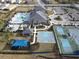 Aerial view of community amenities including a pool, playground, clubhouse and tennis courts at 32212 Mahogany Valley Dr, Wesley Chapel, FL 33543