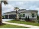 Beautiful single-story home featuring a manicured lawn and a two-car garage at 32212 Mahogany Valley Dr, Wesley Chapel, FL 33543