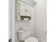 Toilet featuring built-in cabinet and linen storage space at 3398 Pinnacle S Ct, Palm Harbor, FL 34684
