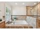 Close-up of bathtub featuring tile surround, faucet, and window for natural light at 3398 Pinnacle S Ct, Palm Harbor, FL 34684