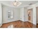Bright bedroom boasts hardwood floors, plantation shutters, and an en-suite bathroom access at 3398 Pinnacle S Ct, Palm Harbor, FL 34684
