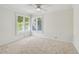 Bright bedroom with neutral carpet, white walls, crown molding, and plantation shutters at 3398 Pinnacle S Ct, Palm Harbor, FL 34684
