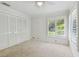 Cozy bedroom with carpet, closet, ceiling fan, and plantation shutters at 3398 Pinnacle S Ct, Palm Harbor, FL 34684