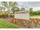 Attractive 'Cobbs Landing' community sign with landscaped flower beds and palm trees at 3398 Pinnacle S Ct, Palm Harbor, FL 34684
