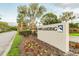 Beautiful entrance sign of Cobb's Landing community, surrounded by lush landscaping and palm trees at 3398 Pinnacle S Ct, Palm Harbor, FL 34684