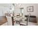 Bright dining area featuring a glass table set for four with an adjacent living area at 3398 Pinnacle S Ct, Palm Harbor, FL 34684