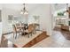 Elegant dining room with chandelier, wainscoting, and large windows with plantation shutters at 3398 Pinnacle S Ct, Palm Harbor, FL 34684