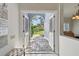 Light and bright entryway with arched doorway and clear view to the outdoors at 3398 Pinnacle S Ct, Palm Harbor, FL 34684