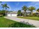 Beautiful home featuring palm trees, a well-manicured lawn, and a three car garage at 3398 Pinnacle S Ct, Palm Harbor, FL 34684