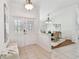 Inviting foyer features decorative glass doors, tile flooring, bench, and access to the dining room at 3398 Pinnacle S Ct, Palm Harbor, FL 34684