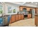 Bright kitchen featuring stainless appliances, beautiful wood cabinetry, granite countertops and tile floors at 3398 Pinnacle S Ct, Palm Harbor, FL 34684