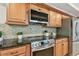 Modern kitchen with stainless steel appliances, granite countertops, and mosaic tile backsplash at 3398 Pinnacle S Ct, Palm Harbor, FL 34684