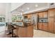 Eat-in kitchen featuring stainless steel appliances, granite counters and wood cabinets at 3398 Pinnacle S Ct, Palm Harbor, FL 34684