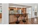 Beautiful kitchen with stainless steel appliances, wood cabinets, granite counters, and modern bar stools at 3398 Pinnacle S Ct, Palm Harbor, FL 34684