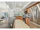Open-concept kitchen with stainless steel appliances, granite countertops, and abundant natural light at 3398 Pinnacle S Ct, Palm Harbor, FL 34684
