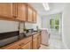 Functional laundry room featuring ample countertop space, storage, and a modern washer at 3398 Pinnacle S Ct, Palm Harbor, FL 34684