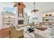 Inviting living room with a stone fireplace, built-in shelving, hardwood floors and plenty of natural light at 3398 Pinnacle S Ct, Palm Harbor, FL 34684
