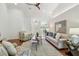 The spacious living room features high ceilings and a cozy seating area with views into other rooms at 3398 Pinnacle S Ct, Palm Harbor, FL 34684