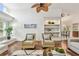 Inviting living room with a stone fireplace, built-in shelving, hardwood floors and plenty of natural light at 3398 Pinnacle S Ct, Palm Harbor, FL 34684
