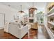 Inviting living room with a stone fireplace, built-in shelving, hardwood floors and plenty of natural light at 3398 Pinnacle S Ct, Palm Harbor, FL 34684