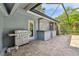 Covered patio with outdoor kitchen, grill, bar area, and brick flooring at 3398 Pinnacle S Ct, Palm Harbor, FL 34684