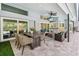 Inviting covered patio features dining, seating, a wet bar, and a built-in grill for outdoor entertaining at 3398 Pinnacle S Ct, Palm Harbor, FL 34684