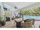 Covered patio with dining table, seating area, and pool view at 3398 Pinnacle S Ct, Palm Harbor, FL 34684