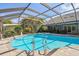 Enjoy Florida living in this spacious screened-in pool and spa with lush landscaping at 3398 Pinnacle S Ct, Palm Harbor, FL 34684