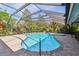 Sparkling pool and spa are surrounded by a screened enclosure and lush landscaping at 3398 Pinnacle S Ct, Palm Harbor, FL 34684