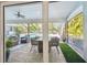 View of the screened-in lanai with a pool and comfortable outdoor seating and dining at 3398 Pinnacle S Ct, Palm Harbor, FL 34684