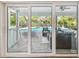 Sliding glass doors open to screened pool and patio, extending indoor living to the outdoors at 3398 Pinnacle S Ct, Palm Harbor, FL 34684