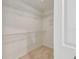 Walk-in closet with built-in shelving, offering ample storage space at 3398 Pinnacle S Ct, Palm Harbor, FL 34684