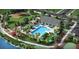 Aerial view of the community clubhouse and pool with lounge chairs and umbrellas at 35105 Brackett Bnd, Zephyrhills, FL 33541