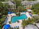 Aerial view of a community pool surrounded by manicured landscaping and apartment buildings, great amenities at 4207 S Dale Mabry Hwy # 3302, Tampa, FL 33611