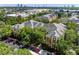 Aerial view of colorful condo community near shopping, showcasing lush trees and parking at 4207 S Dale Mabry Hwy # 3302, Tampa, FL 33611