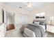 Well-lit bedroom with white trim, a ceiling fan, closet doors, and artwork above the bed at 4207 S Dale Mabry Hwy # 3302, Tampa, FL 33611