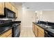 Kitchen featuring granite countertops, stainless steel appliances, and wood cabinetry at 4207 S Dale Mabry Hwy # 3302, Tampa, FL 33611
