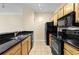 Kitchen featuring granite countertops, stainless steel appliances, and wood cabinetry at 4207 S Dale Mabry Hwy # 3302, Tampa, FL 33611