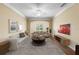 Bright living room with a large arched window, hardwood floors, and cozy neutral-toned furniture at 4207 S Dale Mabry Hwy # 3302, Tampa, FL 33611