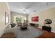 Bright living room with a large arched window, hardwood floors, and cozy neutral-toned furniture at 4207 S Dale Mabry Hwy # 3302, Tampa, FL 33611