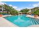 Community pool with luxurious lounge area and lush greenery, inviting relaxation and socializing at 4207 S Dale Mabry Hwy # 3302, Tampa, FL 33611